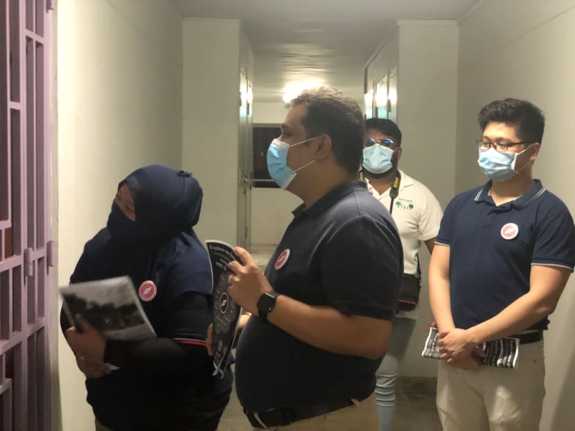 Red Dot United’s secretary-general Ravi Philemon and candidates Liyana Dhamirah and Nicholas Tang seen distributing flyers and surgical masks to residents in Clementi.