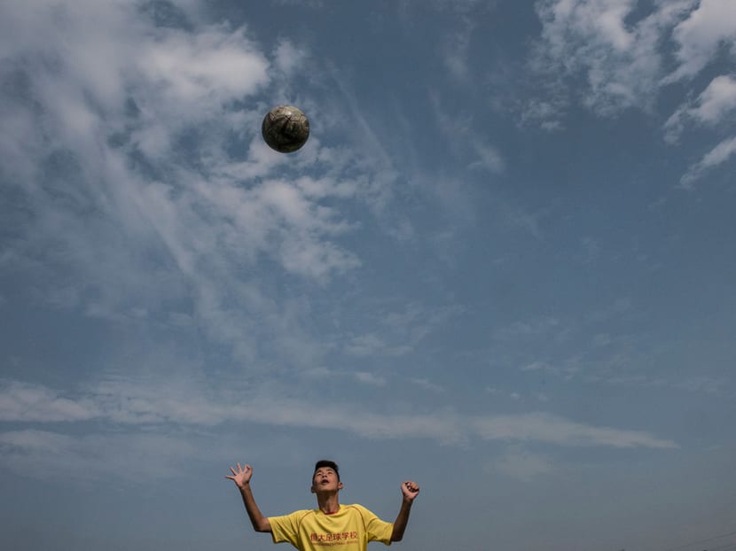 A student practices his headers at the Evergrande Football School, the world’s biggest soccer boarding academy, in Qingyuan, China, Dec 6, 2016. Photo: The New York Times