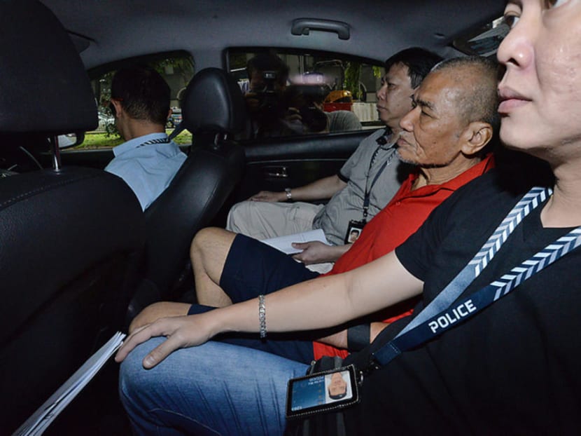 Toh Sia Guan (in red shirt) is accused of murdering Goh Eng Thiam on July 9, 2016.