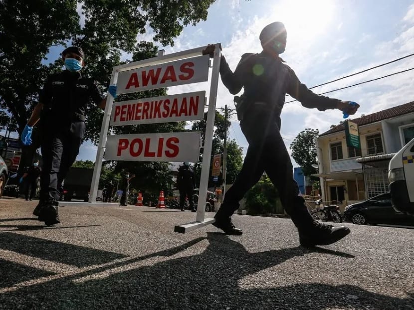 Policemen are seen setting up a roadblock at Jalan Perak in George Town, Penang on Tuesday, April 14, 2020.