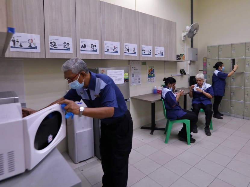 Outsourced cleaners at Jurong Point mall take a break in a rest area equipped with lockers, a fridge and microwave ovens, among other amenities.