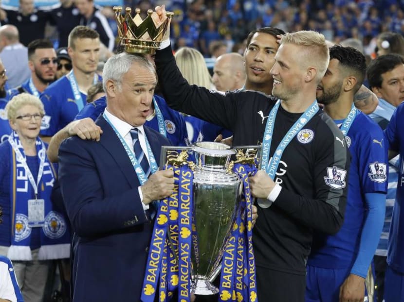 In file photo taken in May 2016, Leicester City manager Claudio Ranieri has the crown of the Premier League trophy placed on his head by goalkeeper Kasper Schmeichel as they celebrate becoming the English Premier League football champions. Leicester have sacked Ranieri less than a year after their incredible run to the Premier League title. Photo: AP