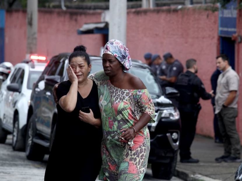 Silvia Palmieri, mother of a teacher, reacts as she leaves Thomazia Montoro school, where a teenager stabbed three teachers and one student, in Sao Paulo, Brazil, March 27, 2023. REUTERS/Carla Carniel