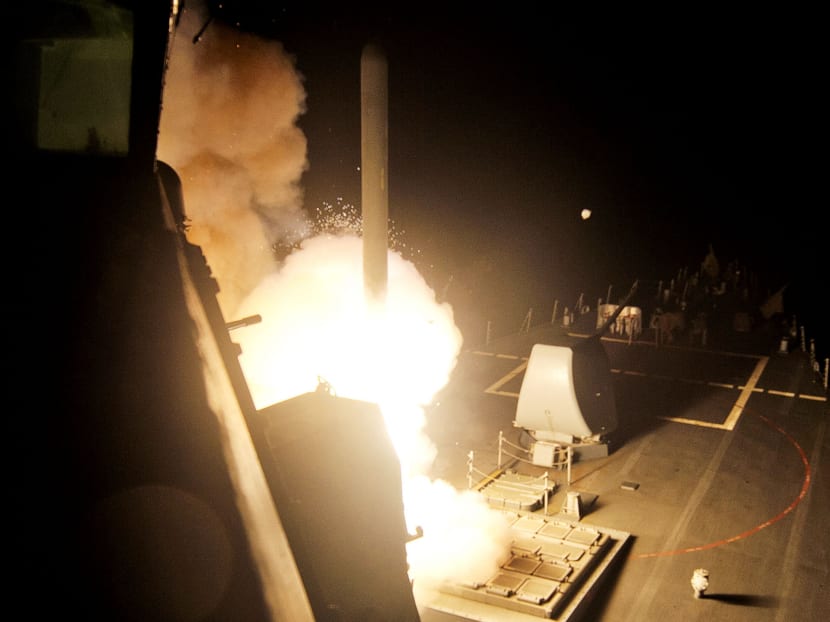 A cruise missile launched against Islamic State targets from a US Navy-guided missile destroyer yesterday. Photo: Reuters