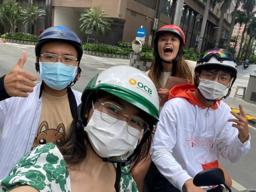 The author (top right) riding pillion on her colleague’s motorcycle in Ho Chi Minh City.

