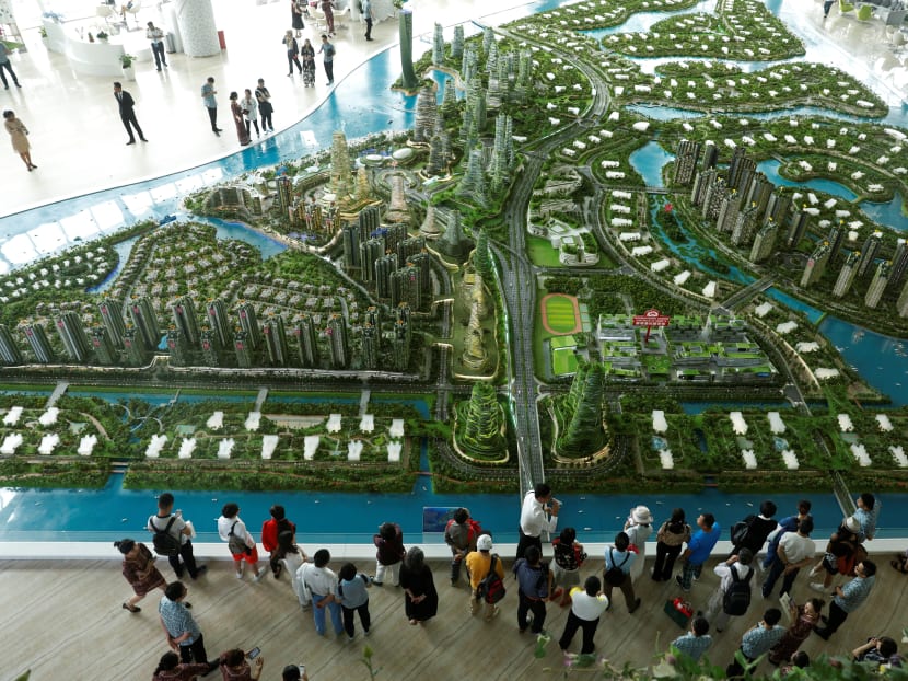 Potential buyers viewing a model of Forest City in a Johor Baru showroom in February. Its developer, Country Garden PacificView, has touted its sustainability and green features. Photo: Reuters Potential buyers viewing a model of Forest City in a Johor Baru showroom in February. Its developer, Country Garden PacificView, has touted its sustainability and green features. Photo: Reuters