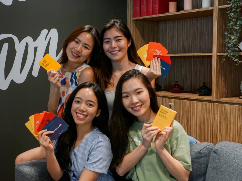 The author (top right) started a campaign against online sexual grooming with three 24-year-old friends: Ms Vanessa Tan (top left), Ms Vinice Yeo (bottom left) and Ms Stephanie Wong, two of whom have had encounters with groomers. They are holding a card game that helps youths talk about their online experiences.