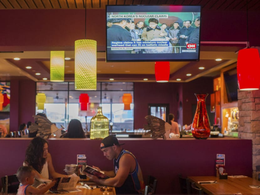 A Guamanian family dining at an Applebee’s in Tamuning. Residents are increasingly worried about Washington’s escalating war of words with North Korea. Photo: The New York Times