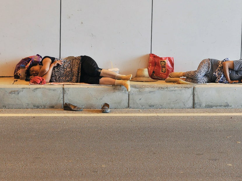 Migrant workers sleeping on the ground in Hefei, Anhui province. Respondents were pessimistic about efforts to reduce social disparity, giving it a 2.64 score. Photo: Reuters
