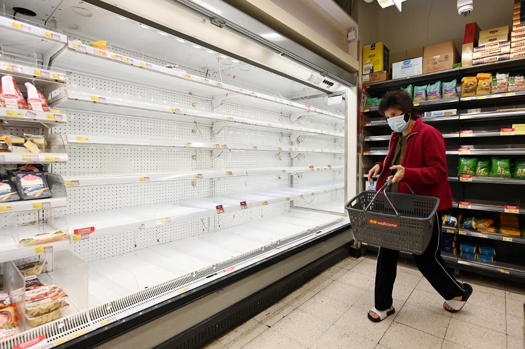 A shopper walks past empty shelves are at a supermarket in Hong Kong on March 1, 2022, as panic buying returned to the city with many supermarket shelves stripped bare following mixed messaging from the government over whether it plans a city lockdown later this month when it tests all residents.
