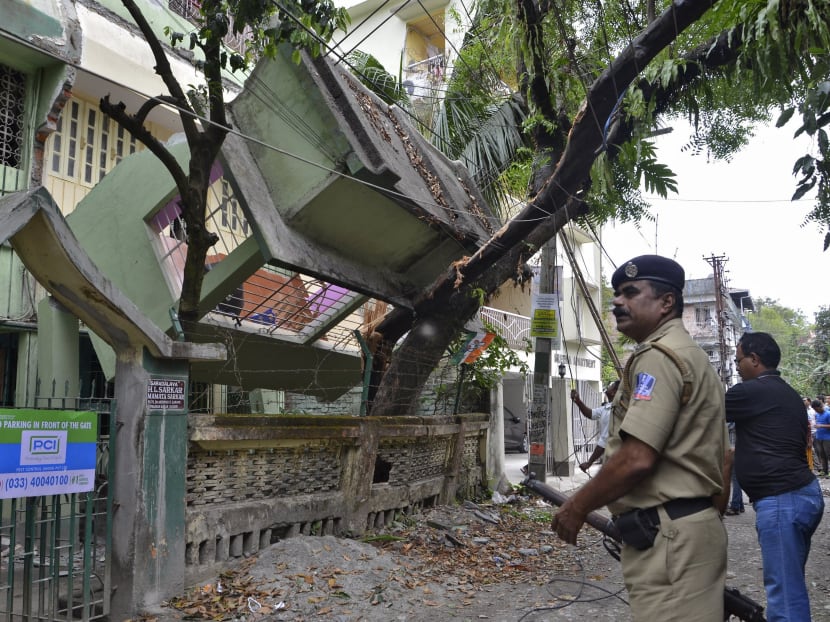 An Indian security personnel stands near a collapsed house in Siliguri, India, after an earthquake measuring 7.9 magnitude struck Nepal and parts of northern India, authorities in both countries said. Photo: Reuters