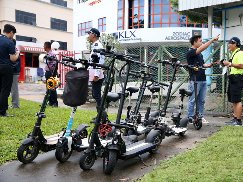 Enforcement officers from the Land Transport Authority impounding the PMDs of several errant riders at Loyang Lane on Monday morning (Jan 15). Photo: Koh Mui Fong/TODAY