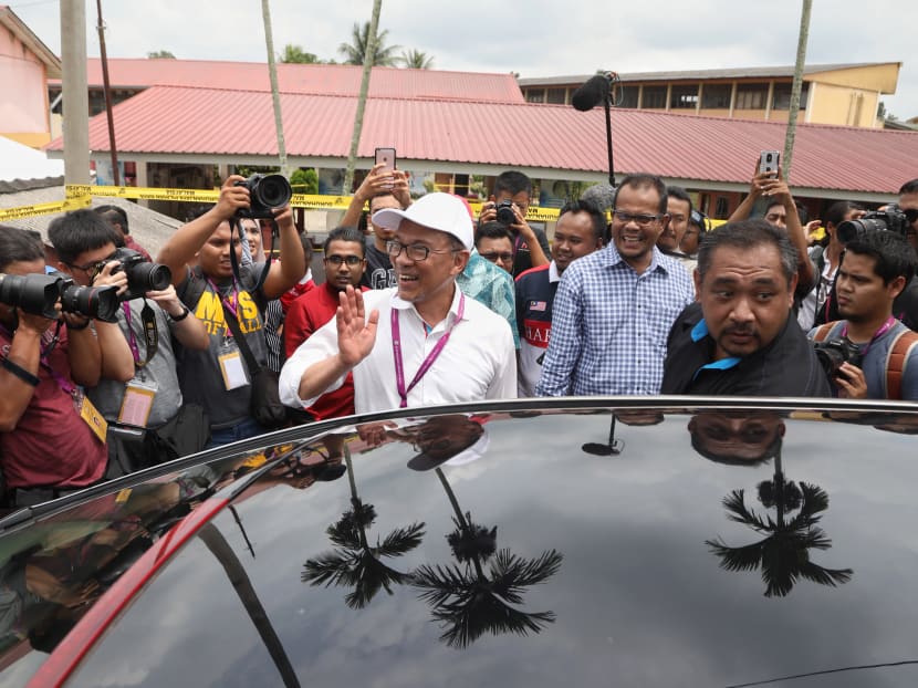 Mr Anwar Ibrahim waving to the media after visiting a polling station during the Port Dickson by-election in October 2018.