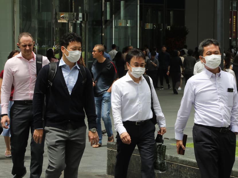 Office workers in Singapore donning masks to prevent the spread of the novel coronavirus.