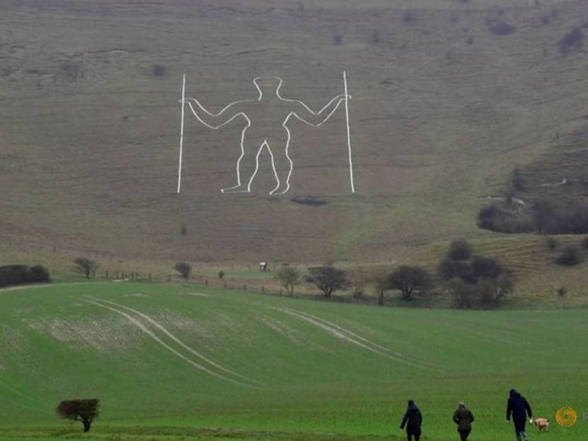 COVID face mask painted on giant English chalk figure COVID face mask painted on giant English chalk figure