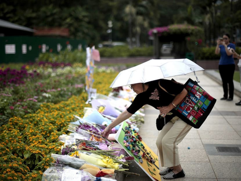 A woman placing flowers at the Lee Kuan Yew tribute site at Istana Park yesterday. Photo: Jason Quah