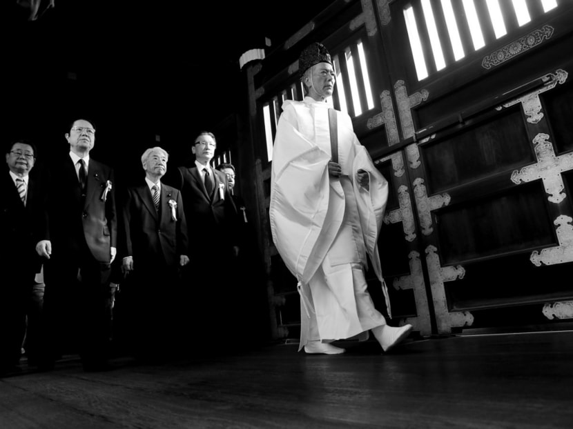 Japanese lawmakers being led by a Shinto priest to pay their respects to Japan’s war dead in the Yasukuni Shrine in Tokyo last year. Whereas Germany 

has been a major source of reconciliation and stability in Europe, Japan — through its uncontrite behaviour— is a source of friction in East Asia. Photo: Reuters