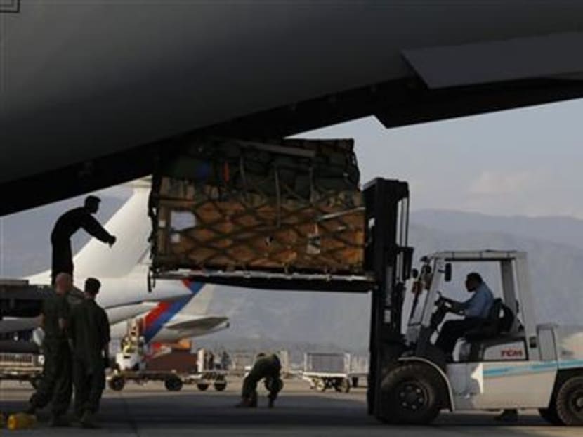 US soldiers unload equipments of Huey Helicopters from a US Air Force Boeing C-17 Globemaster III shortly after it landed in Tribhuvan International Airport in Kathmandu, Nepal, yesterday (May 3). Photo: AP