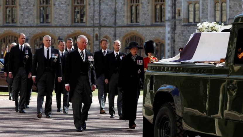 Queen Elizabeth stands alone as Philip is laid to rest; William and Harry talk