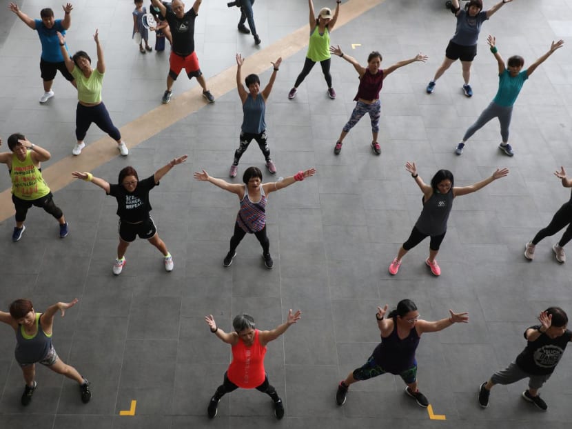 Participants joining in a Zumba workout, an aerobic activity, at the launch of the Singapore Physical Activity Guidelines at Canberra Plaza on June 12, 2022.