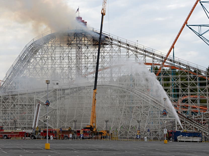 Los Angeles County firefighters work to control a blaze atop the recently closed Colossus wooden roller coaster at Southern California's Six Flags Magic Mountain on Sept 8, 2014.  Photo: AP