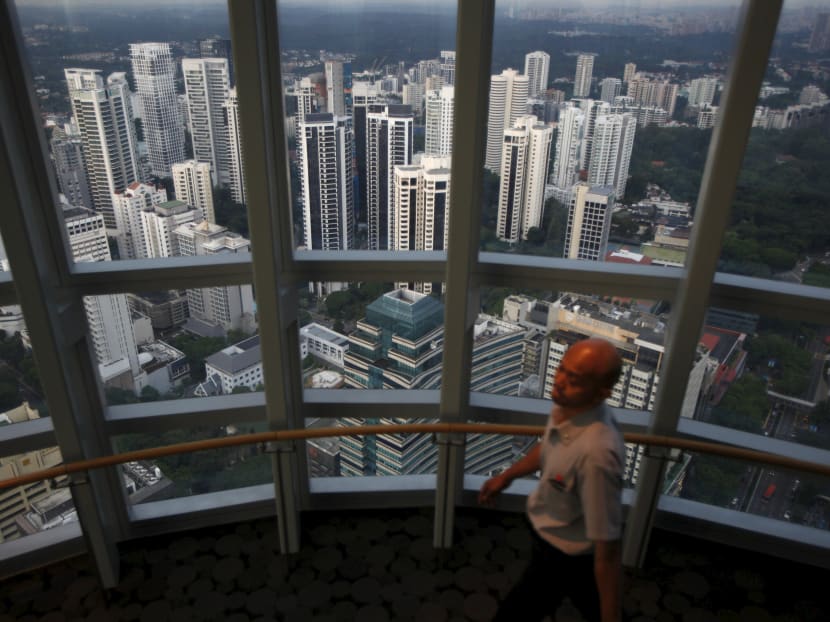 A man walks on an observation deck overlooking private high-rise residential condominium properties in the prime Orchard Road district in this Singapore April 15, 2014 file photo. Photo: Reuters