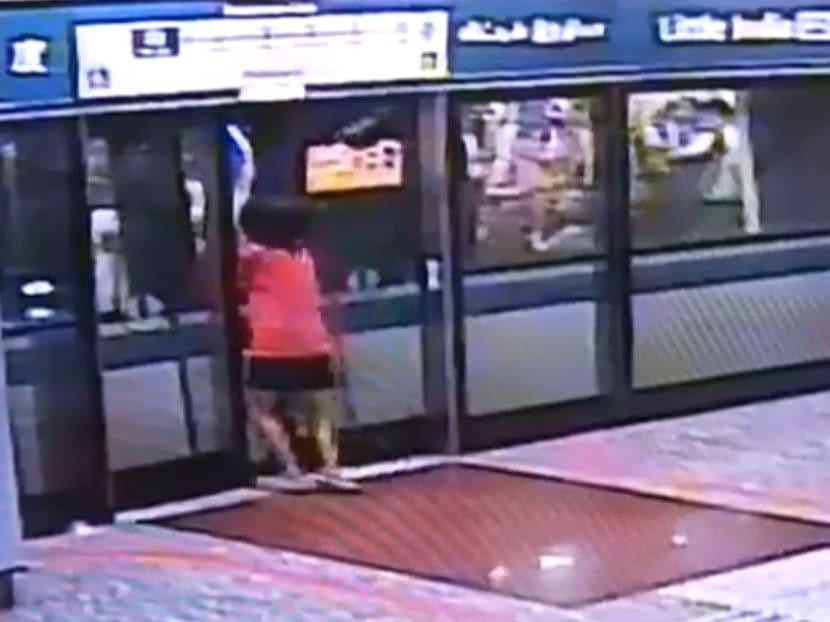 Closed-circuit television footage showed a passenger squeezing through the platform screen doors at an MRT station and trying to pry open the train doors.