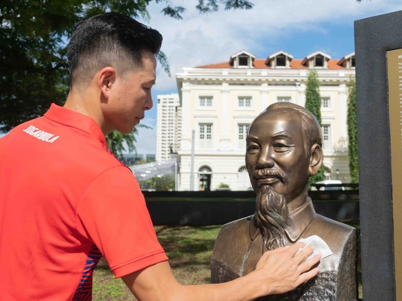 Mr Duong Doan, a Vietnamese national living in Singapore, is pictured cleaning a bronze statue of the nation's former leader Ho Chi Minh located at Clarke Quay.