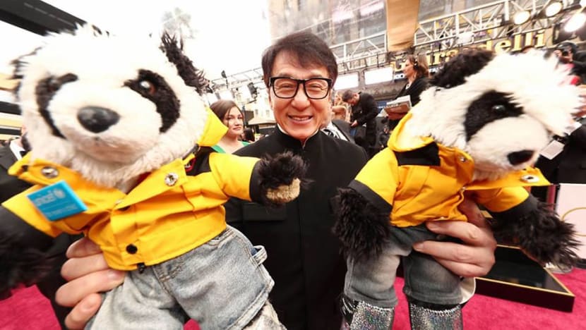 Jackie Chan walks Oscars red carpet with toy pandas