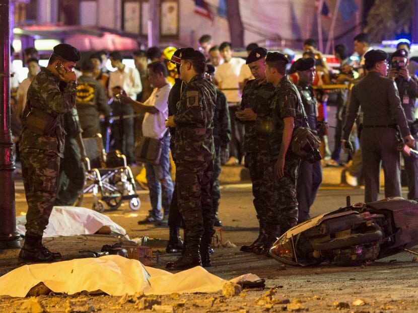 Bodies of victims are covered with white sheet as security forces and emergency workers gather at the scene of the blast in central Bangkok August 17, 2015. Photo: Reuters
