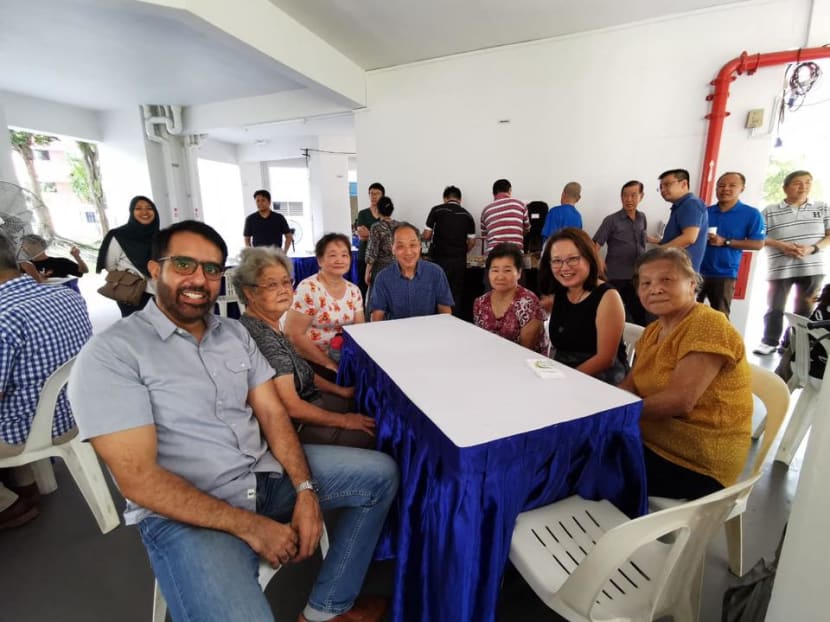 Workers' Party's Members of Parliament Pritam Singh (left), Low Thia Khiang (fourth from left) and Sylvia Lim (second from right) sitting with some residents they were visiting at Aljunied GRC on Nov 2, 2019.