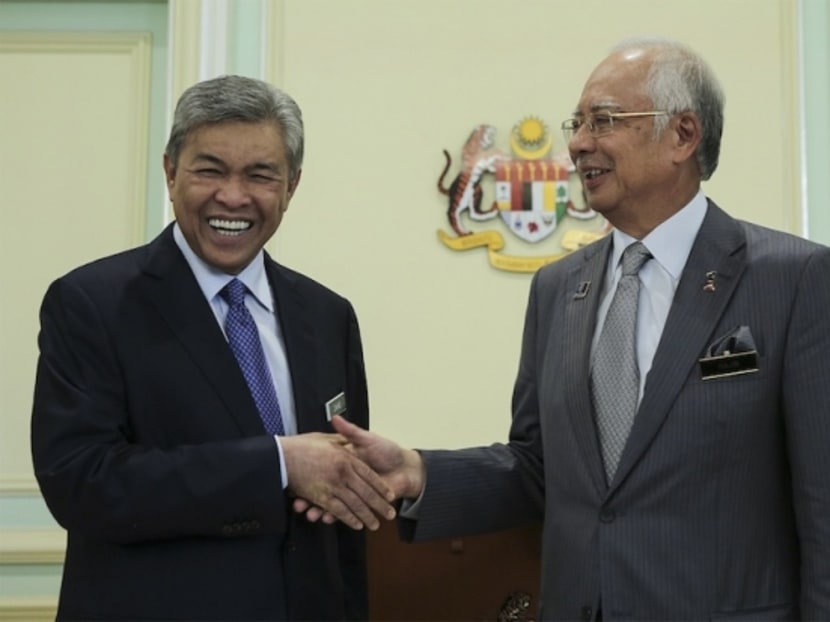 Prime Minister Najib Razak shakes hands with his new deputy, Zahid Hamidi, at the Prime Minister Office in Putrajaya, July 28, 2015. Photo: The Malay Mail Online