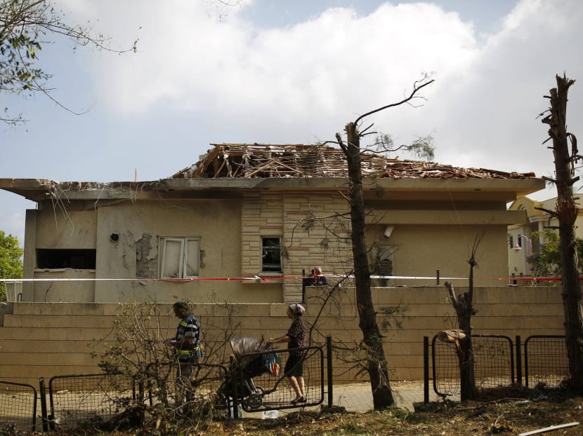 A house in Ashkelon struck by a rocket from Gaza yesterday. The attack left 10 people lightly wounded. Photo: REUTERS