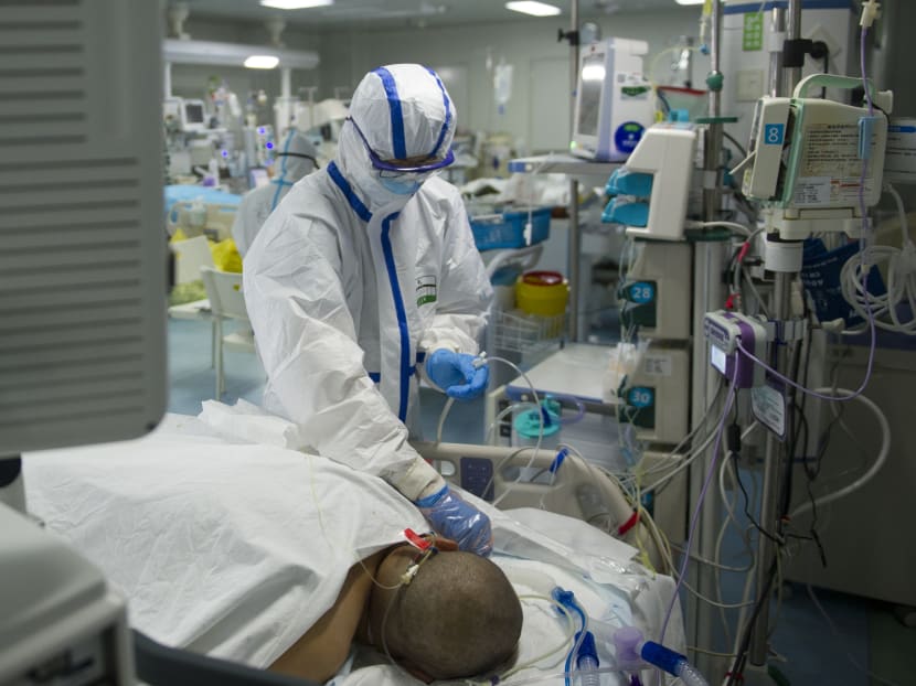 A nurse checks a patient in an intensive care unit treating Covid-19 coronavirus patients at a hospital in Wuhan, in China's central Hubei province.