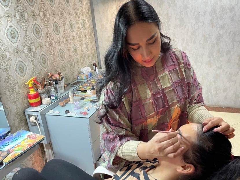 In this photograph taken on Oct 18, 2021, a beautician applies make-up to a customer at a beauty salon in Kabul. In this photograph taken on Oct 18, 2021, a beautician applies make-up to a customer at a beauty salon in Kabul.