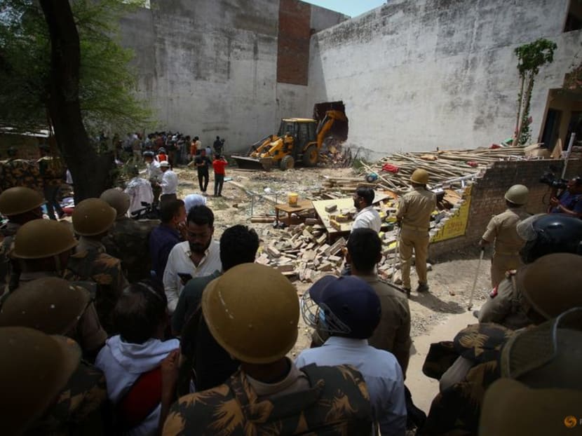 A bulldozer demolishes the house of a Muslim man that Uttar Pradesh state authorities accuse of being involved in riots last week, that erupted following comments about the Prophet Mohammed by India's ruling Bharatiya Janata Party (BJP) members, in Prayagraj, India, June 12, 2022. Authorities claim the house was illegally built.