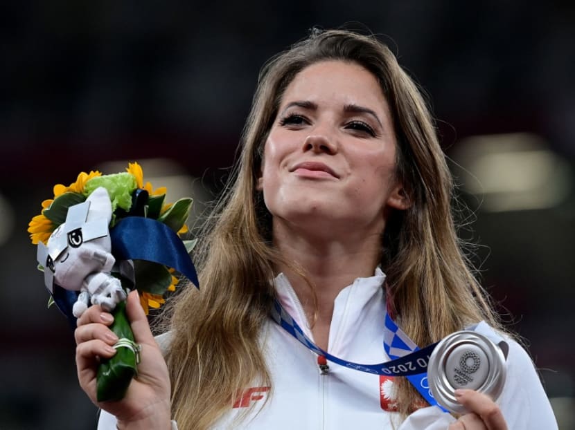 Silver medallist Poland's Maria Andrejczyk celebrates on the podium during the victory ceremony for the women's javelin throw event during the Tokyo 2020 Olympic Games at the Olympic Stadium in Tokyo on Aug 7, 2021.