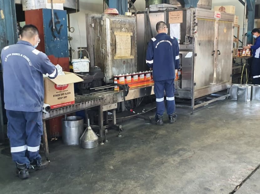 Workers at Aik Moh Paints & Chemicals observing safe distancing measures by standing 1m apart at each station. Workers at Aik Moh Paints & Chemicals observing safe distancing measures by standing 1m apart at each station.