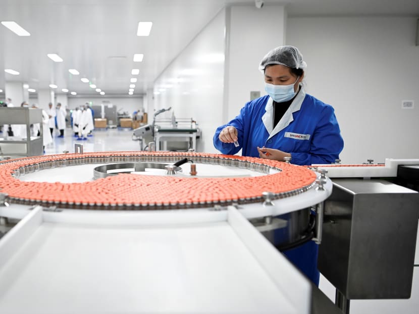 A staff member works during a media tour of a new factory built to produce a Covid-19 coronavirus vaccine at Sinovac, one of 11 Chinese companies approved to carry out clinical trials of potential coronavirus vaccines in Beijing on Sept 24, 2020. A staff member works during a media tour of a new factory built to produce a Covid-19 coronavirus vaccine at Sinovac, one of 11 Chinese companies approved to carry out clinical trials of potential coronavirus vaccines in Beijing on Sept 24, 2020.