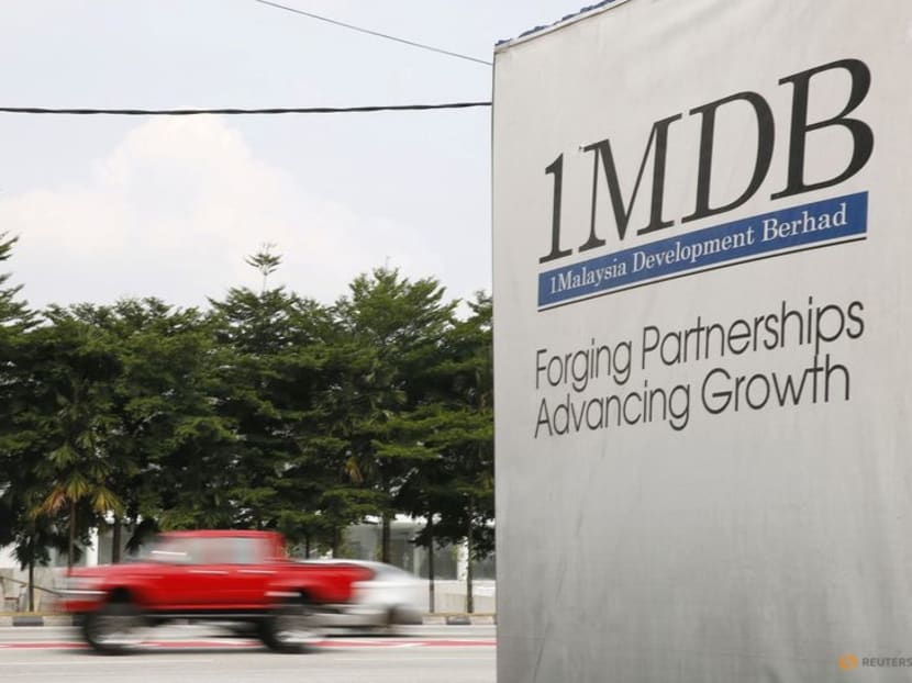 Traffic passes a 1Malaysia Development Berhad (1MDB) billboard at the Tun Razak Exchange development in Kuala Lumpur, Malaysia, July 6, 2015.