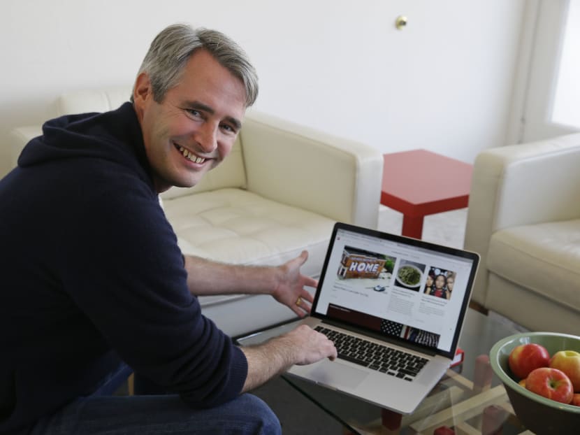 Flipboard founder and chief executive Mike McCue poses with a laptop computer displaying his digital magazine at his company's headquarters in Palo Alto, California, Jan 22, 2015. Photo: AP