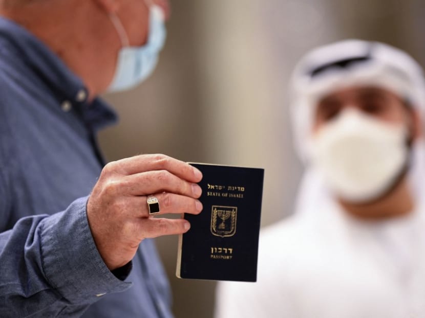 An Israeli man presents his passport for control upon arrival from Tel Aviv to the Dubai airport in the United Arab Emirates, on Nov 26, 2020, on the first scheduled commercial flight operated by budget airline flydubai, following the normalisation of ties between the UAE and Israel.