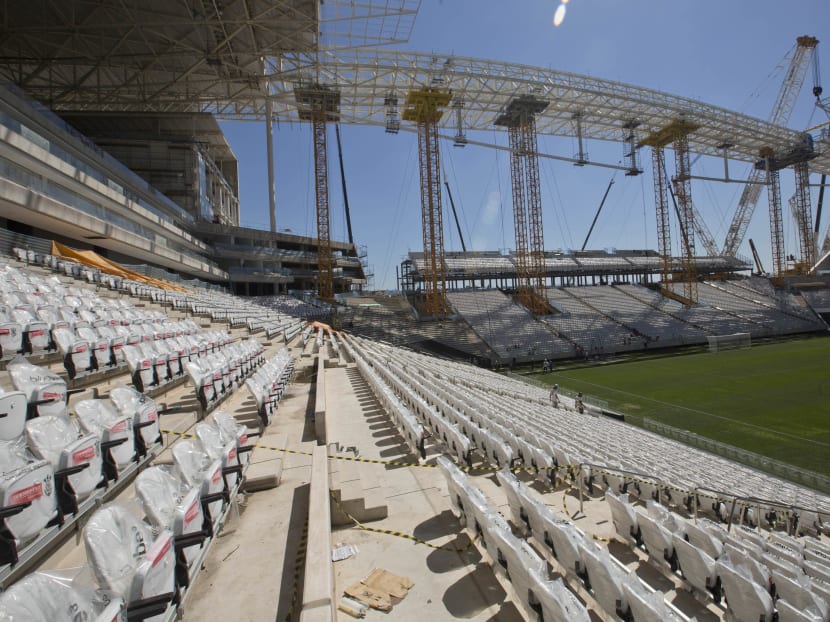 Men work at the Itaquerao, the stadium that will host the World Cup opener in less than three months in Sao Paulo, Brazil, Saturday, March 15, 2014. Photo: AP