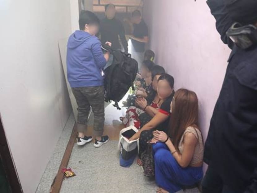Twenty-two people were arrested for their suspected involvement in vice-related activities during police raids at brothels in the vicinity of Rowell Road. Photo: Singapore Police Force