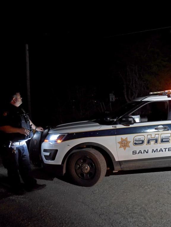 A San Mateo County sheriff deputy stands guard at the scene of a shooting on highway 92 in Half Moon Bay, California on January 23, 2023. 