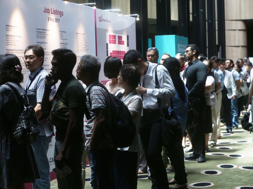 A long queue of people waiting to enter the Adapt And Grow job fair at Crowne Plaza Changi Airport, where more than 2,300 jobs at Changi Airport are looking to be filled. Photo: TODAY