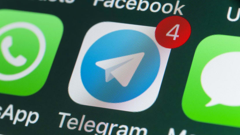 stockcam telegram whatsapp messages and other phone apps on iphone screen stock photo