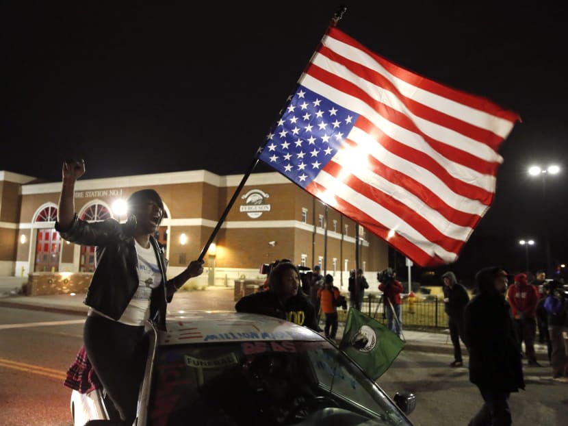 Gina Gowdy joins protesters on the street outside a Ferguson fire station. Photo: AP