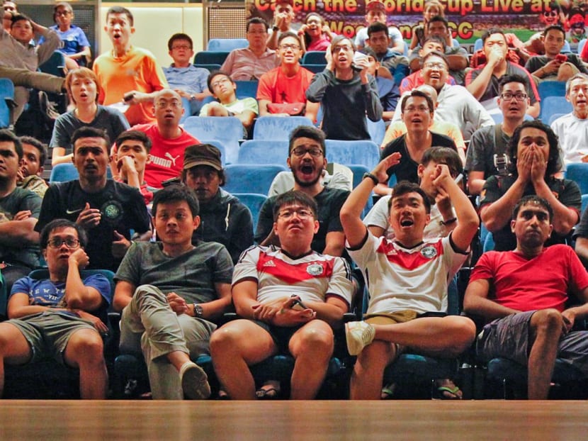 Football fans at Woodlands Community Club cheer after Brazil score during their World Cup 2014 match against Croatia. Photo: Don Wong