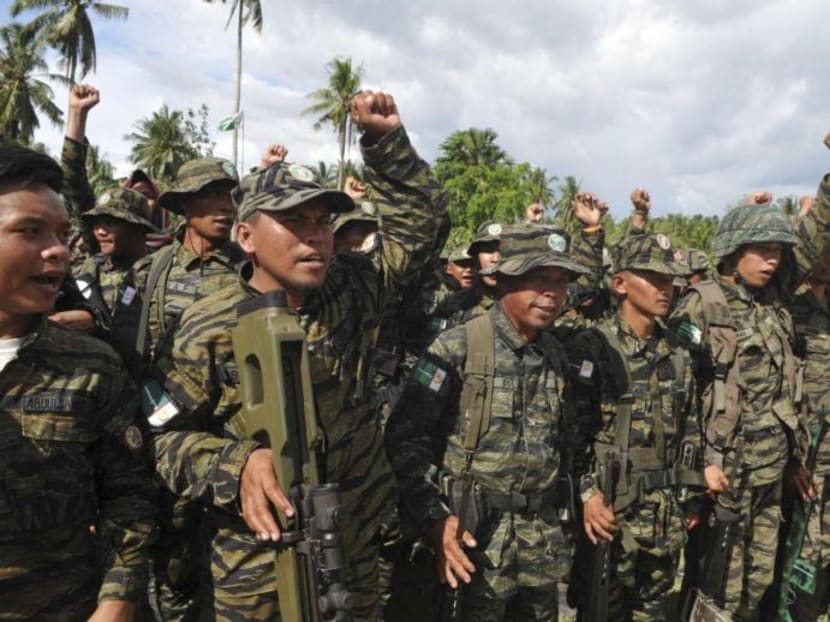 Moro Islamic Liberation Front (MILF) forces raise their fists during a show of force. Photo: Reuters